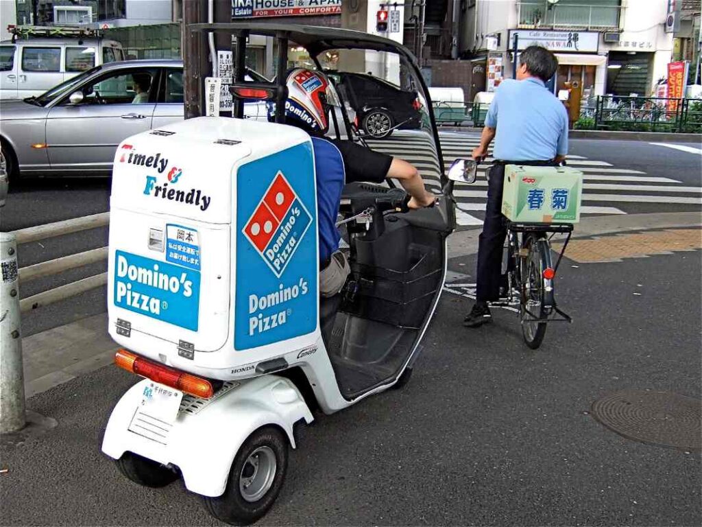Delivery scooter at a road intersection
