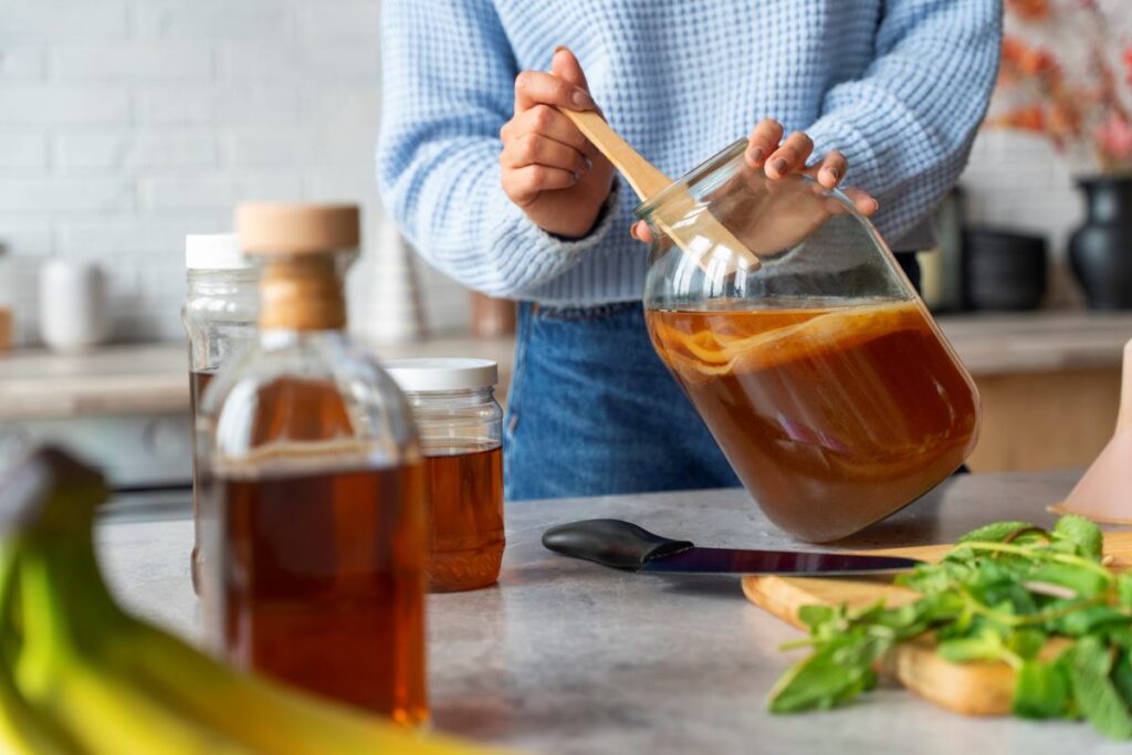 Woman preparing a homemade kombucha recipe