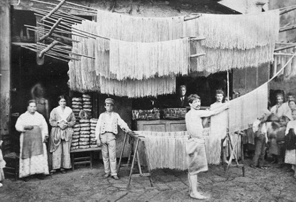 Pasta drying out on the racks outside of a pasta shop in Palermo, Italy, 1865