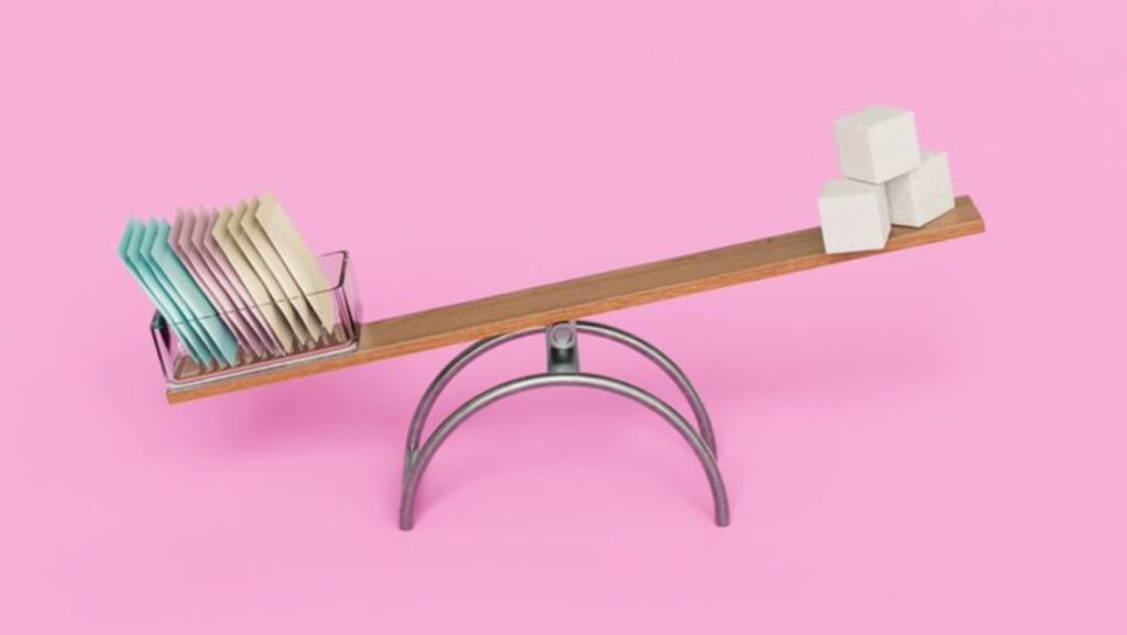 Artificial sweeteners and cane sugar on a seesaw
