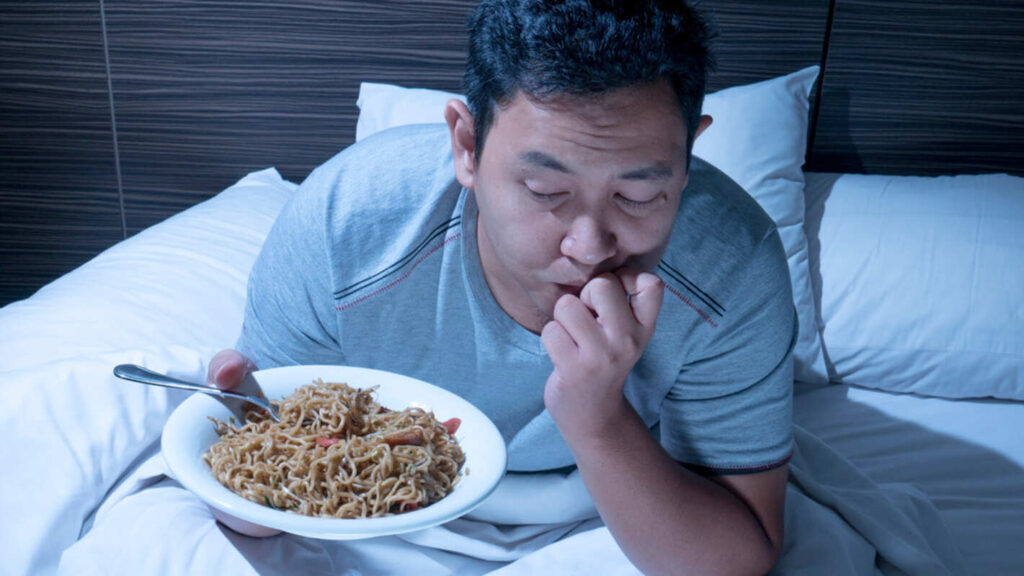 A man about to have a heavy meal right before bed