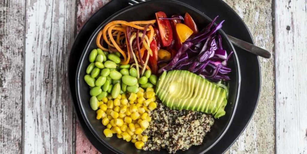 Quinoa veggie bowl of avocado, Edamame, tomatoes, corn, red cabbage