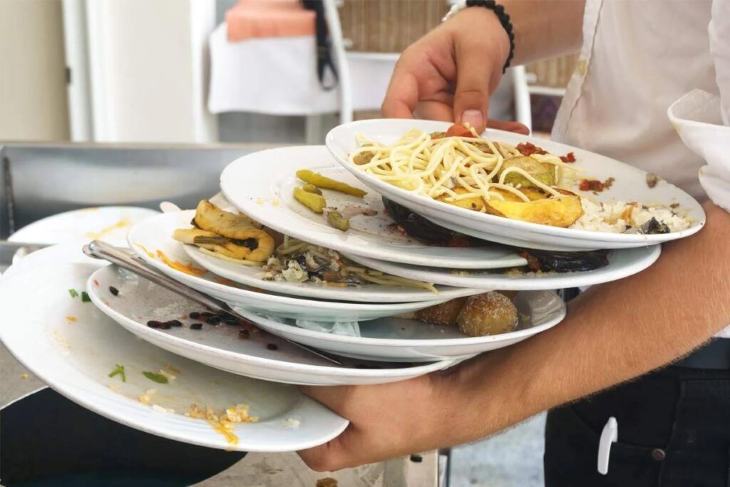 Service staff hauling dirty dishes to the kitchen