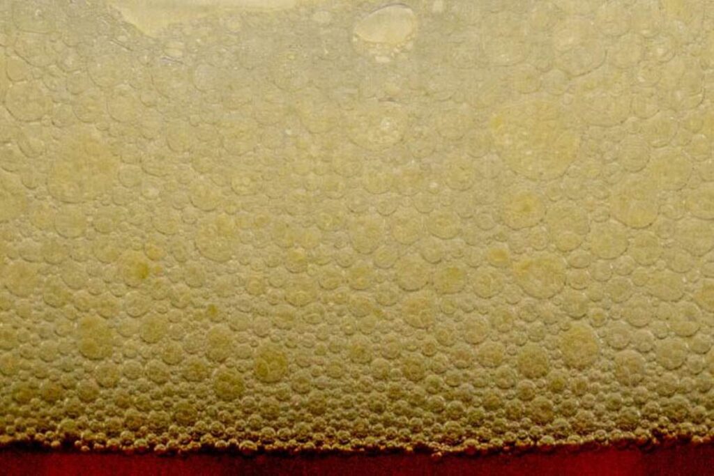 Foam forming on the top of a liquid food product rich in surfactants