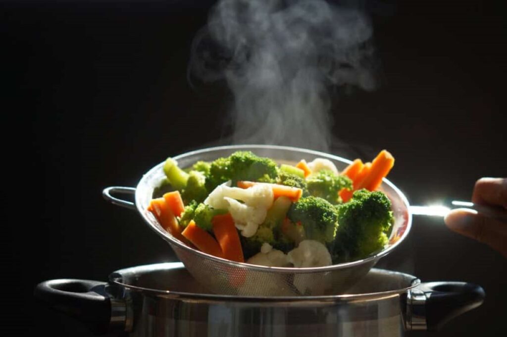 Steaming of hot boiled vegetables basket of vegetables