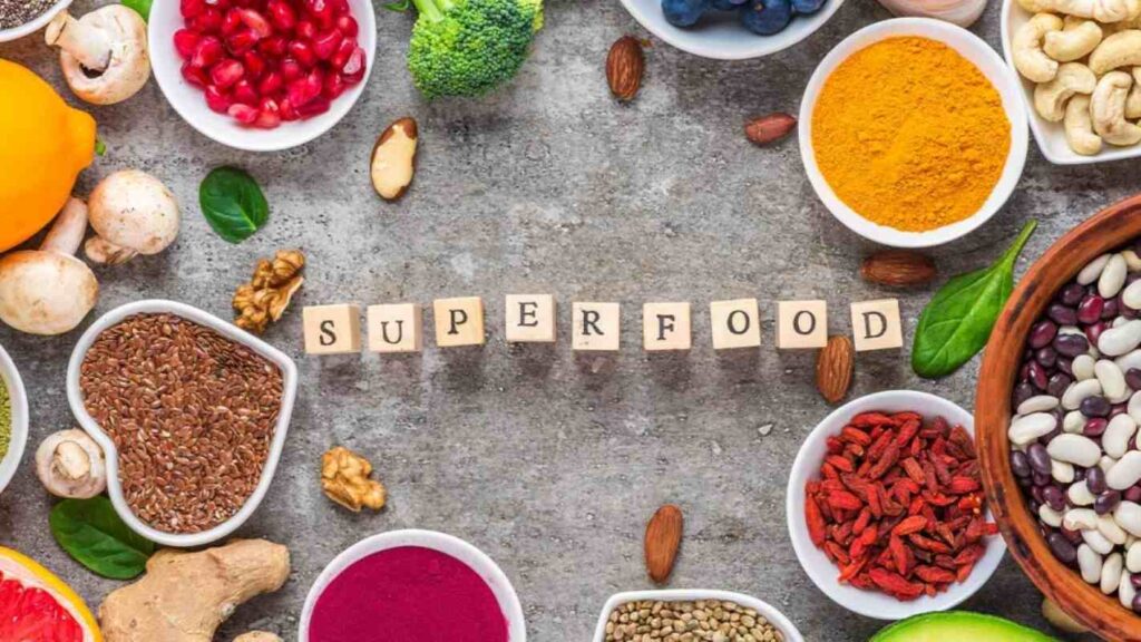 Frame of superfood clean eating selection: fruit, vegetable, seeds, superfood, nuts, berries