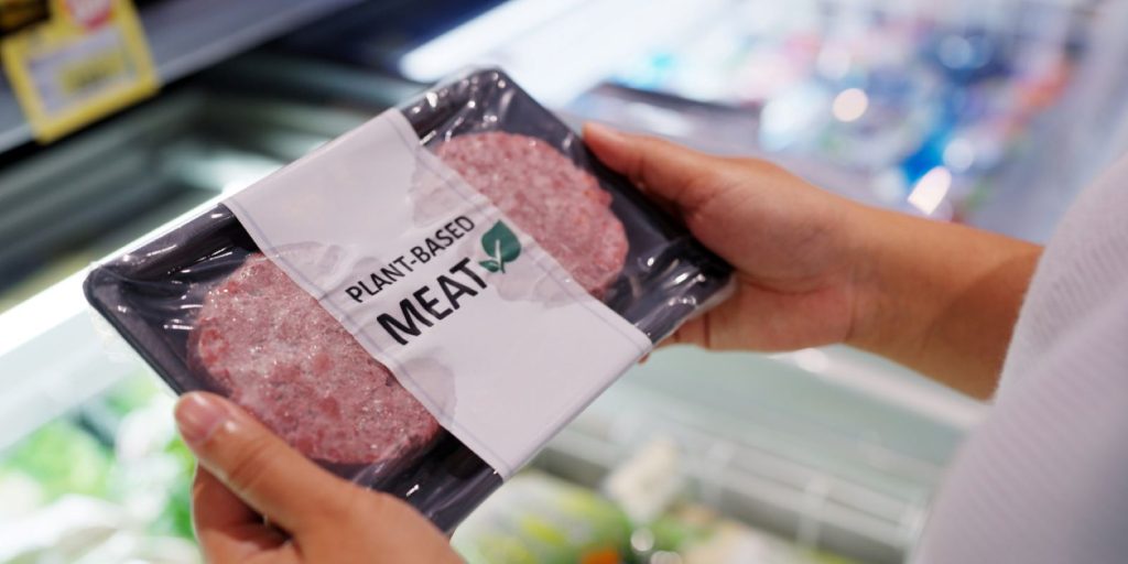 A shopper considering whether to try out plant-based meat