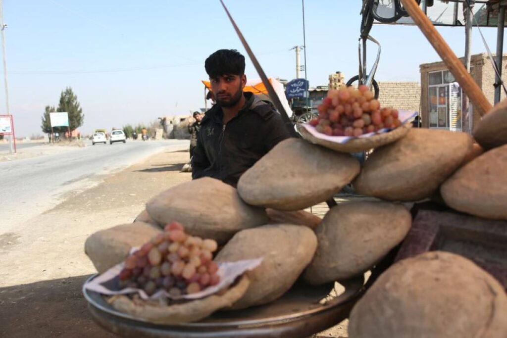 An Afghan street vendor sells grapes in the Kalakan district of Kabul, the capital of Afghanistan
