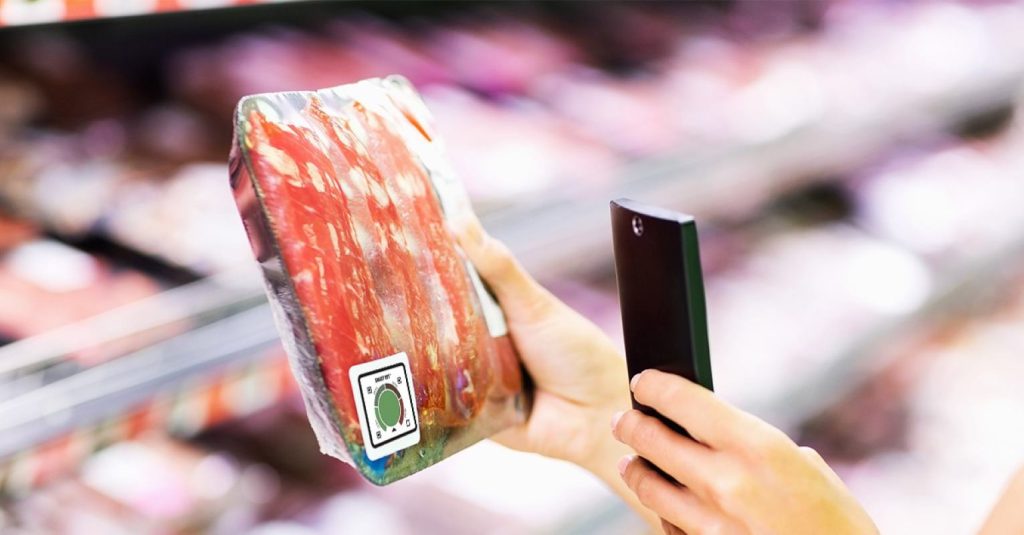 Shopper using QR code to trace the source of food 