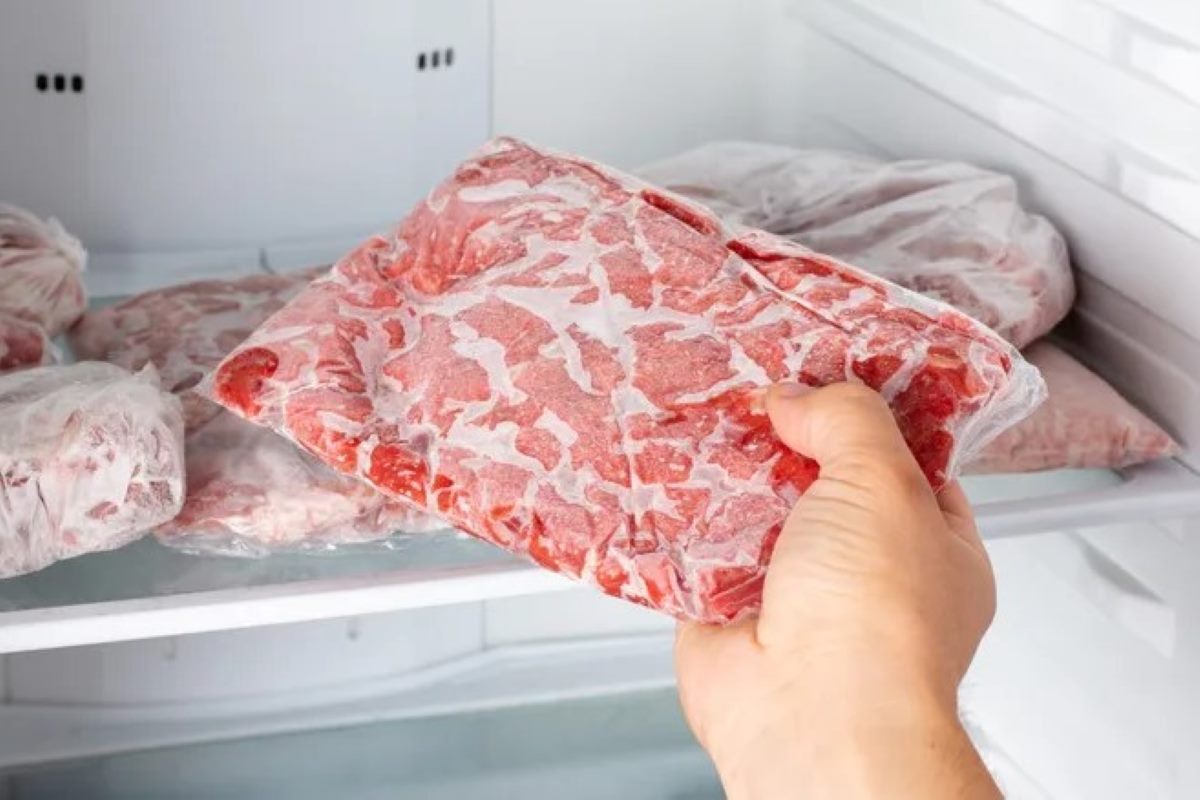 Man taking out frozen meat from the freezer