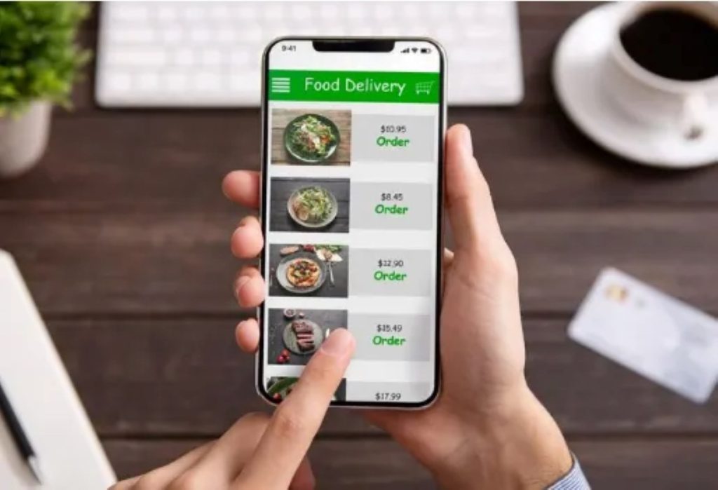 Hand touching phone screen for choosing food 