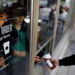 A customer picking up an order at a Starbucks pick-up only outlet