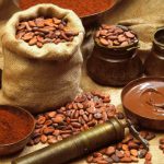 Grind cacao beans near beans in a sack