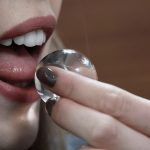 A woman putting a seaweed water pod in her mouth