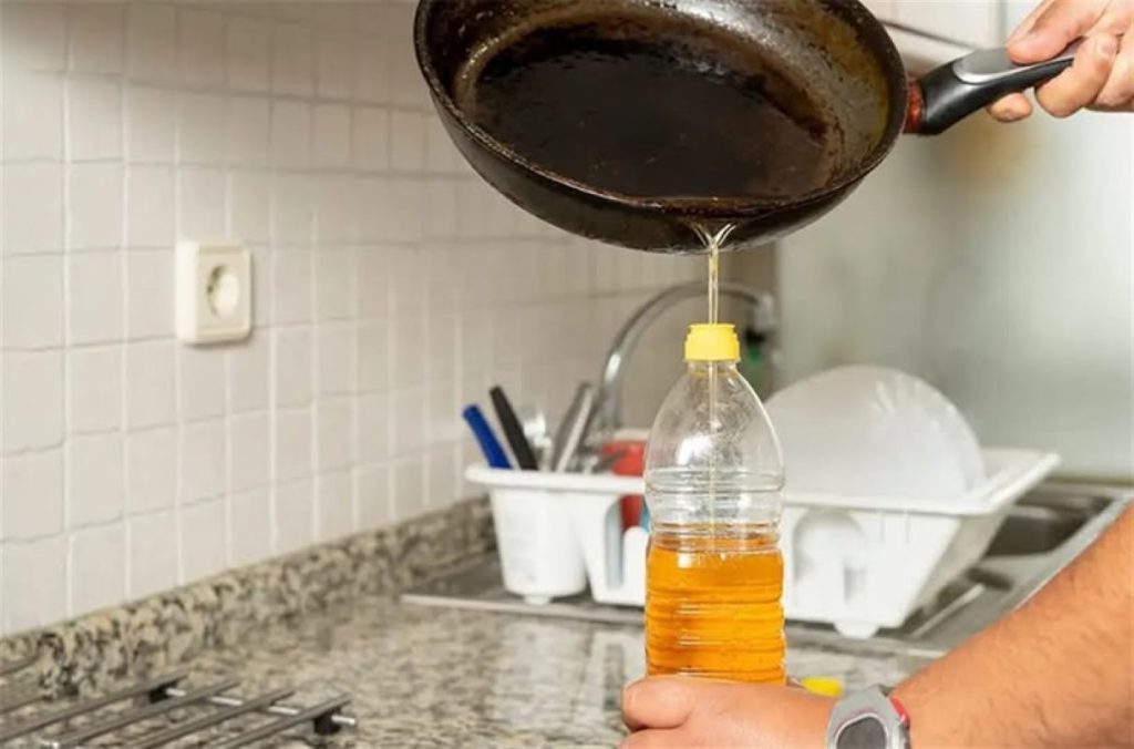 Dispensing used oil into a plastic bottle