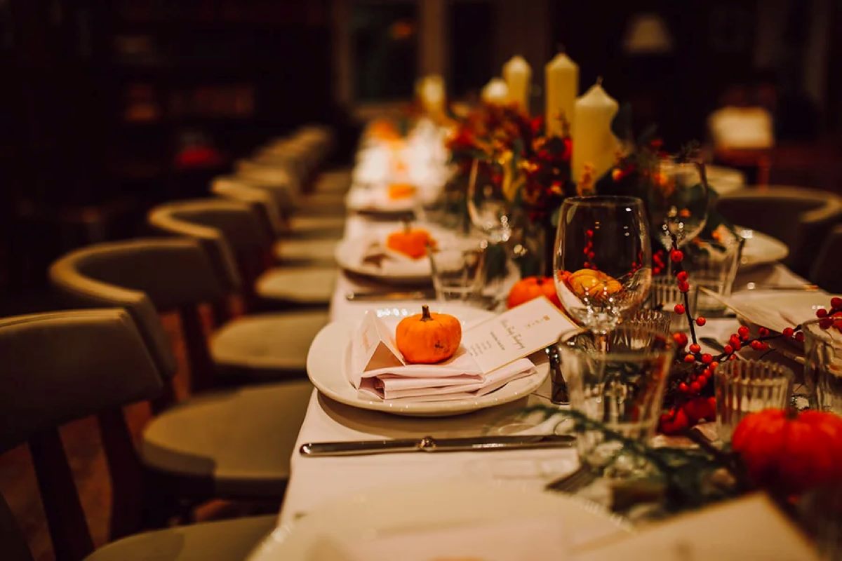 Fall-themed restaurant setting with a long table and chairs