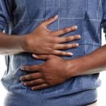 A hungry man grabbing his stomach