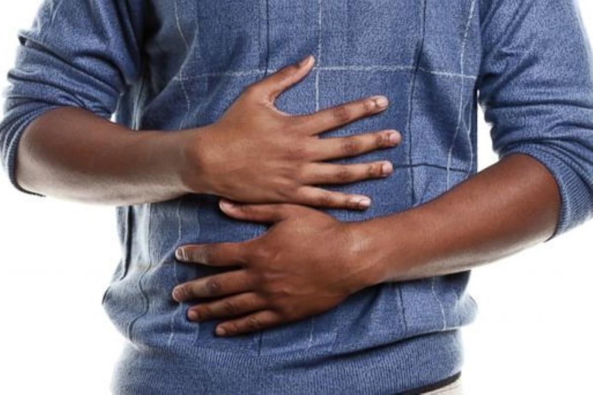 A hungry man grabbing his stomach