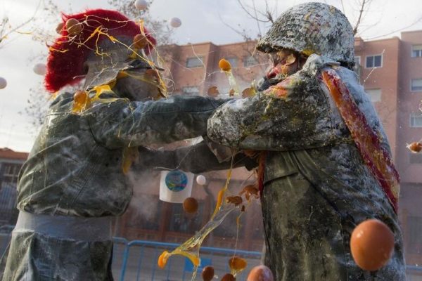 They battle using flour, eggs and firecrackers outside the city town hall as part of the celebrations of the Day of the Innocents, a traditional day in Spain for pulling pranks