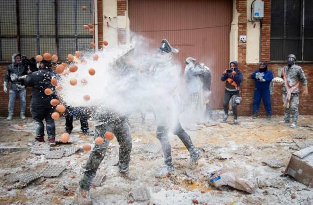 Revellers dressed in mock military garb take part in "Els Enfarinats", a 200-year-old traditional winter festival