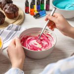 A confectioner mixing batters with different colors