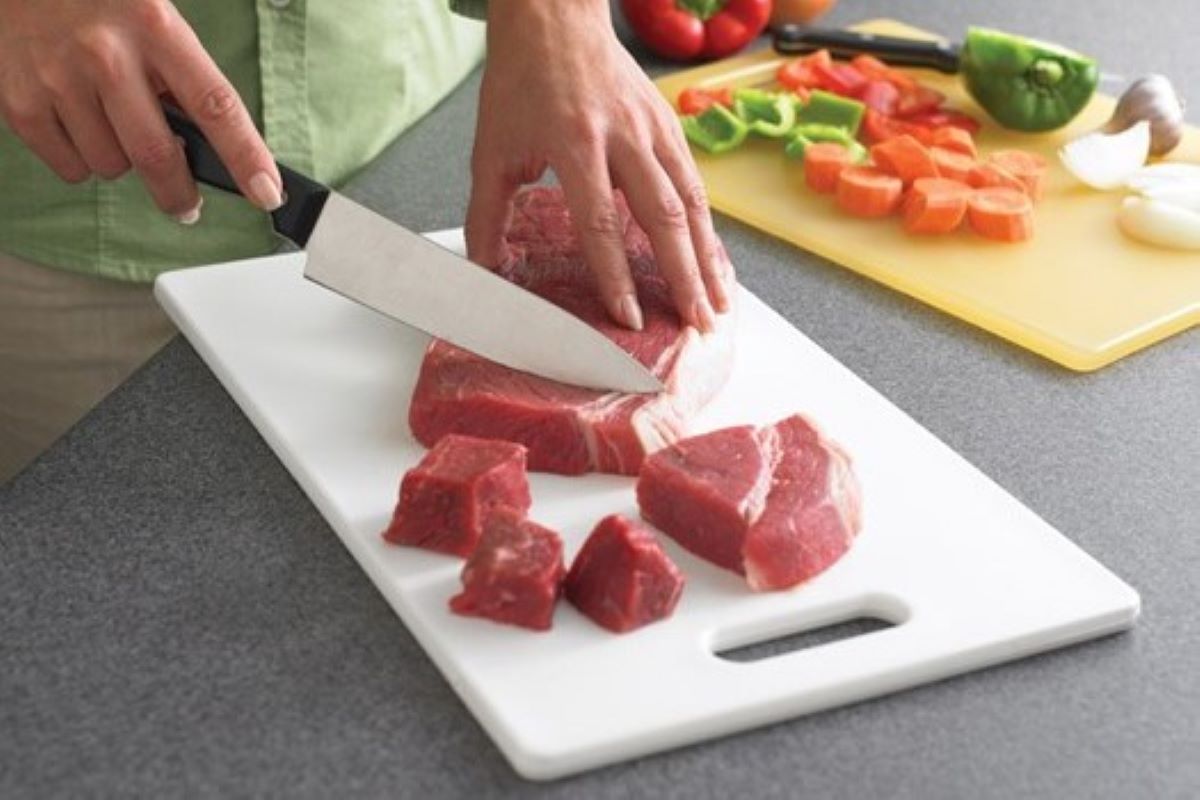 Using separate cutting boards — one for raw meat and poultry and another for ready-to-eat foods