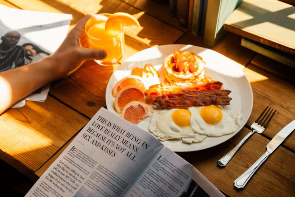 An image of someone reading a magazine over breakfast