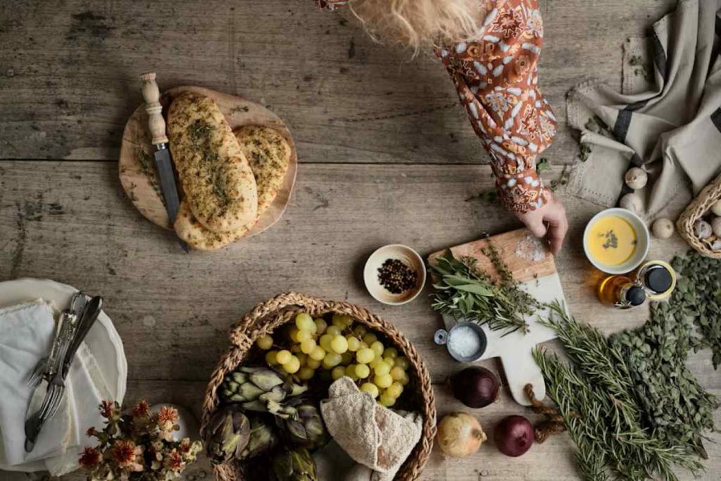 a table topped with a basket of fruit and vegetables