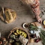 a table topped with a basket of fruit and vegetables