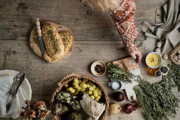 a table topped with a basket of fruit and vegetables
