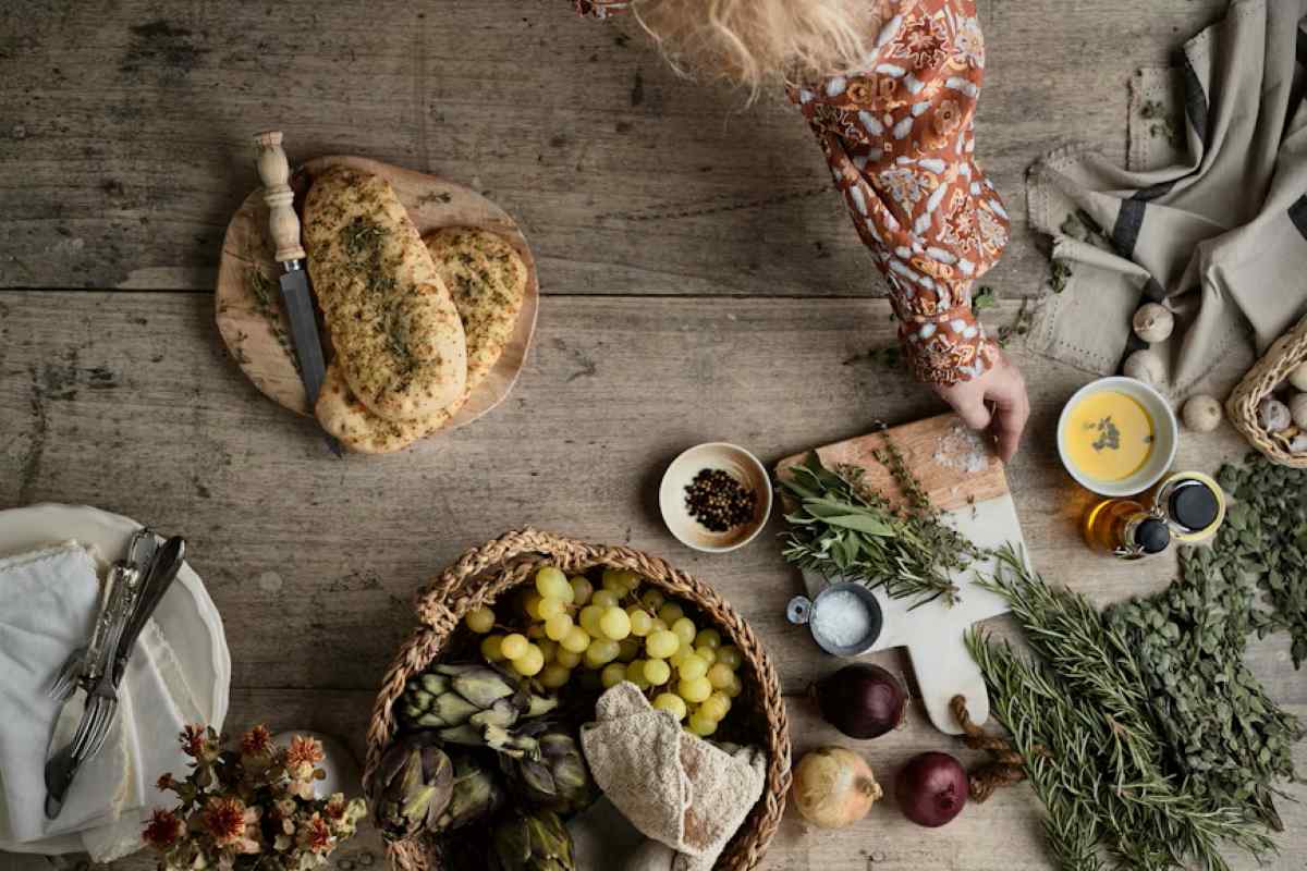 a table topped with a basket of fruit and vegetables