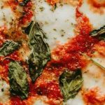 Top crust of a pizza with basil