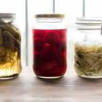 three jars filled with different types of fermented food