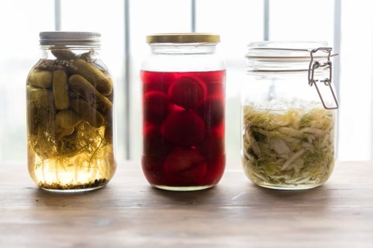 three jars filled with different types of fermented food