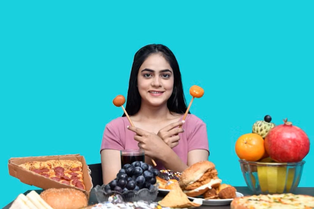 a woman holding a spoon in her mouth with food in front of her