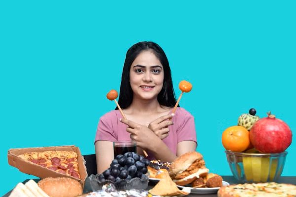a woman holding a spoon in her mouth with food in front of her